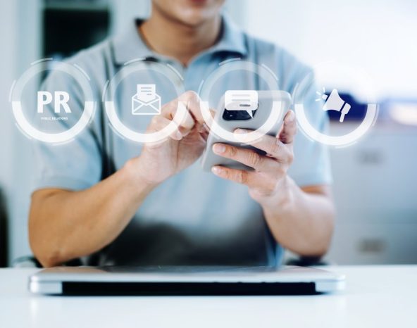 Franchise PR Canada – hands using a phone with public relations icons